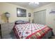 Bedroom with a ceiling fan, comfortable bed with a quilt and framed prints on the wall at 1301 Pridgen Rd. # 1101, Myrtle Beach, SC 29577