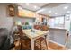 Open dining room features hardwood floors, a dining table set for four, and a view into the kitchen at 1301 Pridgen Rd. # 1101, Myrtle Beach, SC 29577