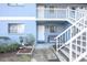 Exterior of blue building with two floors, stairs and landscaping at 1301 Pridgen Rd. # 1101, Myrtle Beach, SC 29577
