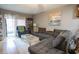 Cozy living room with a large gray sectional sofa, patterned rug, and sliding glass doors to the outside at 1301 Pridgen Rd. # 1101, Myrtle Beach, SC 29577