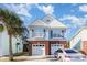 Charming two-story home with a two-car garage and a well-manicured lawn at 1341 Brown Pelican Dr., Myrtle Beach, SC 29577