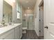 Bright bathroom featuring white vanity, framed mirror, and glass-enclosed shower at 1451 Porchfield Dr., Conway, SC 29526