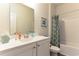 Bright bathroom featuring white vanity and shower with patterned curtain at 1451 Porchfield Dr., Conway, SC 29526