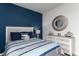Comfortable bedroom with blue accent wall, patterned bedding, and decorative mirror above dresser at 1451 Porchfield Dr., Conway, SC 29526