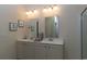 Bathroom featuring double sink vanity, framed mirrors, modern lighting and accessories at 1454 Porchfield Dr., Conway, SC 29526