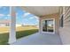 Covered back patio with a concrete floor and sliding glass doors, overlooking a spacious green lawn at 1459 Porchfield Dr., Conway, SC 29526