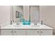Bathroom featuring double sinks, white cabinetry, and modern fixtures at 1459 Porchfield Dr., Conway, SC 29526