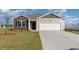 Charming home featuring a two-car garage, neutral siding, and a well manicured lawn at 1459 Porchfield Dr., Conway, SC 29526