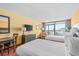 Comfortable bedroom featuring two beds, a desk, dresser and a balcony with scenic views at 1501 S Ocean Blvd. # 1005, Myrtle Beach, SC 29577