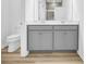 Bathroom featuring double vanity, sleek cabinets, modern fixtures and tile shower at 155 Joyce Dr, Longs, SC 29568