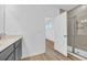 Bathroom features a glass enclosed shower and granite counter with dark wood cabinets at 155 Joyce Dr, Longs, SC 29568