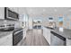 Bright kitchen with stainless steel appliances, granite countertops, and a view to the backyard at 155 Joyce Dr, Longs, SC 29568