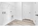 Functional laundry room featuring shelving and wood-look flooring at 155 Joyce Dr, Longs, SC 29568