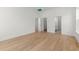 Spacious bedroom featuring natural light and hardwood floors, with multiple access doorways and a neutral color palette at 1587 Sayebrook Pkwy., Myrtle Beach, SC 29588