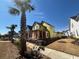 New construction home with bright yellow wrap, front porch, and situated on a grassy lot at 1587 Sayebrook Pkwy., Myrtle Beach, SC 29588