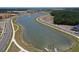 Aerial view of community pond with road frontage and new construction in the distance at 1587 Sayebrook Pkwy., Myrtle Beach, SC 29588