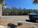 View of a residential street with a modern home, landscaping, and a parked SUV at 1587 Sayebrook Pkwy., Myrtle Beach, SC 29588