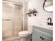 Bathroom featuring a shower with glass doors, white ship lap walls, and blue vanity at 1733 Neptune Rd., Myrtle Beach, SC 29575