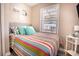 Inviting bedroom featuring a colorful quilt, natural light, and a bedside table at 1733 Neptune Rd., Myrtle Beach, SC 29575
