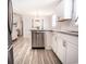Bright kitchen features stainless steel appliances, white cabinets, light countertops, and modern light fixtures at 1733 Neptune Rd., Myrtle Beach, SC 29575