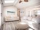 Cozy living room featuring wood-look floors, skylights, and comfortable seating arrangements at 1733 Neptune Rd., Myrtle Beach, SC 29575