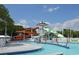 Resort-style community pool featuring a waterslide, lazy river, sunning deck, and tropical palm trees at 1733 Neptune Rd., Myrtle Beach, SC 29575