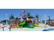 Community splash zone offering colorful flags, a play structure, lounge chairs, and tropical palms at 1733 Neptune Rd., Myrtle Beach, SC 29575