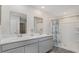 Bright bathroom with double vanity, large mirror, and walk-in shower with a patterned shower curtain at 178 Ashworth Dr., Tabor City, NC 28463