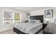 Cozy bedroom featuring a queen-sized bed with blue and white striped bedding, side tables, and natural light at 178 Ashworth Dr., Tabor City, NC 28463