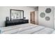 Comfortable bedroom with view of a window through a black framed mirror above a dark dresser at 178 Ashworth Dr., Tabor City, NC 28463