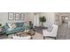 Comfortable living room featuring a teal sofa, white accent chair, and stylish decor at 178 Ashworth Dr., Tabor City, NC 28463