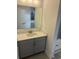 Bathroom featuring a quartz vanity top, gray cabinets, and a large framed mirror at 179 Glengrove Lane, Murrells Inlet, SC 29576