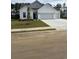 Charming single-Gathering home featuring a three-car garage and a well-manicured front yard at 179 Glengrove Lane, Murrells Inlet, SC 29576