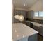 Bright kitchen featuring gray cabinetry, quartz countertops, and designer pendant lighting at 179 Glengrove Lane, Murrells Inlet, SC 29576