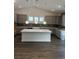 Modern kitchen with gray cabinets, a spacious island, and elegant pendant lighting at 179 Glengrove Lane, Murrells Inlet, SC 29576