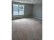 Spacious bedroom with unfinished floors, a large window, and neutral paint, awaiting your personal touch at 180 Glengrove Lane, Murrells Inlet, SC 29576