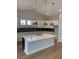 Modern kitchen with white cabinets, quartz countertops, blue backsplash, and pendant lighting at 180 Glengrove Lane, Murrells Inlet, SC 29576