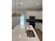 Bright and modern kitchen with a center island, stainless steel appliances, and stylish lighting at 180 Glengrove Lane, Murrells Inlet, SC 29576