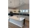 Bright, eat-in kitchen featuring pendant lights, white cabinets, and a large center island at 180 Glengrove Lane, Murrells Inlet, SC 29576