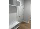 Mudroom with white cabinets, built-in bench, and hardwood floors at 180 Glengrove Lane, Murrells Inlet, SC 29576