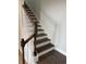 Wooden staircase with white railing and hardwood floors at 180 Glengrove Lane, Murrells Inlet, SC 29576