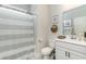 Bright bathroom featuring a shower with striped curtain, a vanity with ample cabinet space, and modern fixtures at 1813 Brook Park Pl., Conway, SC 29526