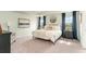 Spacious bedroom with plush carpeting, tray ceiling, elegant decor, and large windows for plenty of natural light at 1813 Brook Park Pl., Conway, SC 29526
