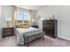 Inviting bedroom features a large window, stylish furniture, and plush bedding for a relaxing retreat at 1813 Brook Park Pl., Conway, SC 29526