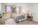 Charming bedroom with bright windows, cozy floral bedding, and colorful decor at 1813 Brook Park Pl., Conway, SC 29526
