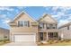 Two-story home with tan siding, stone accents, a two-car garage, and a well-manicured lawn at 1813 Brook Park Pl., Conway, SC 29526