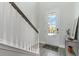 Bright foyer with light gray floors, white trim, and decorative 