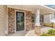 Covered porch and front door area with stone accents and white columns at 1813 Brook Park Pl., Conway, SC 29526