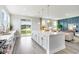Open-concept kitchen with a large island, stainless steel appliances, and sliding glass doors at 1813 Brook Park Pl., Conway, SC 29526