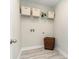 Functional laundry room with shelving, washer hookup, storage, and modern tile flooring at 1813 Brook Park Pl., Conway, SC 29526